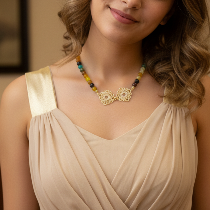 Woman wearing a necklace with a beige dress against a neutral background