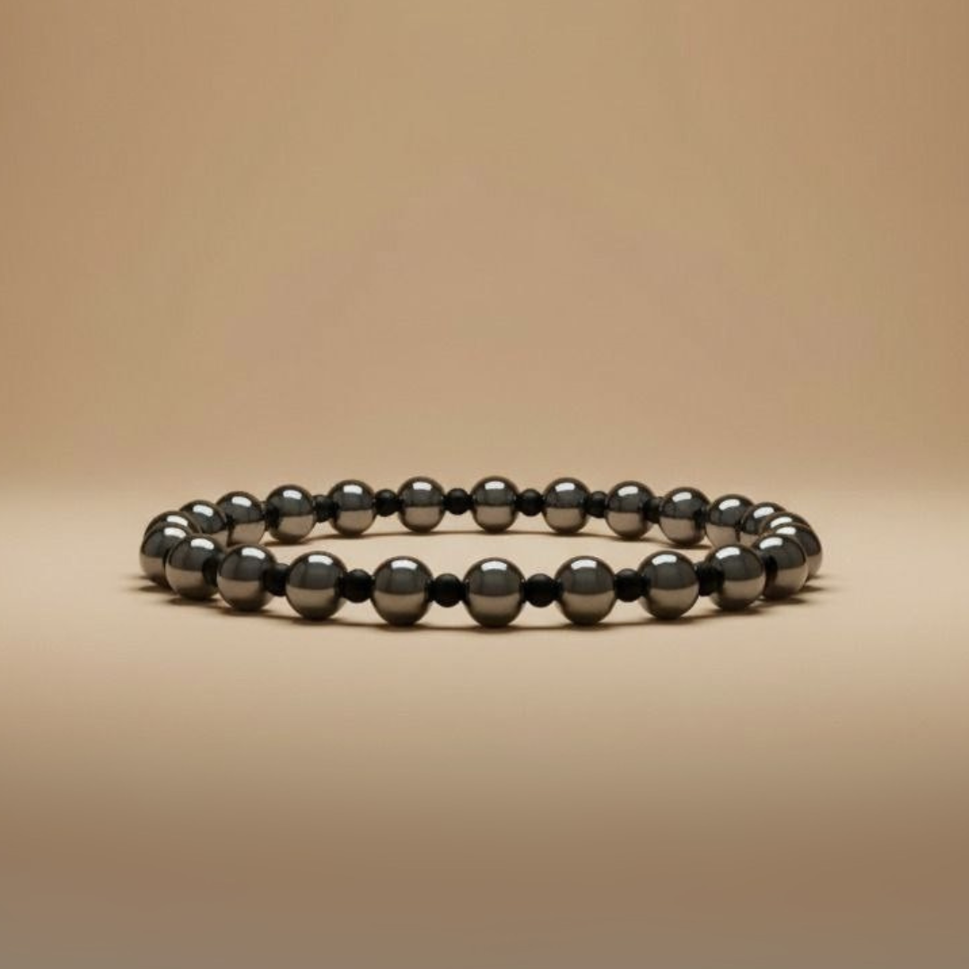 Black beaded bracelet on a beige background