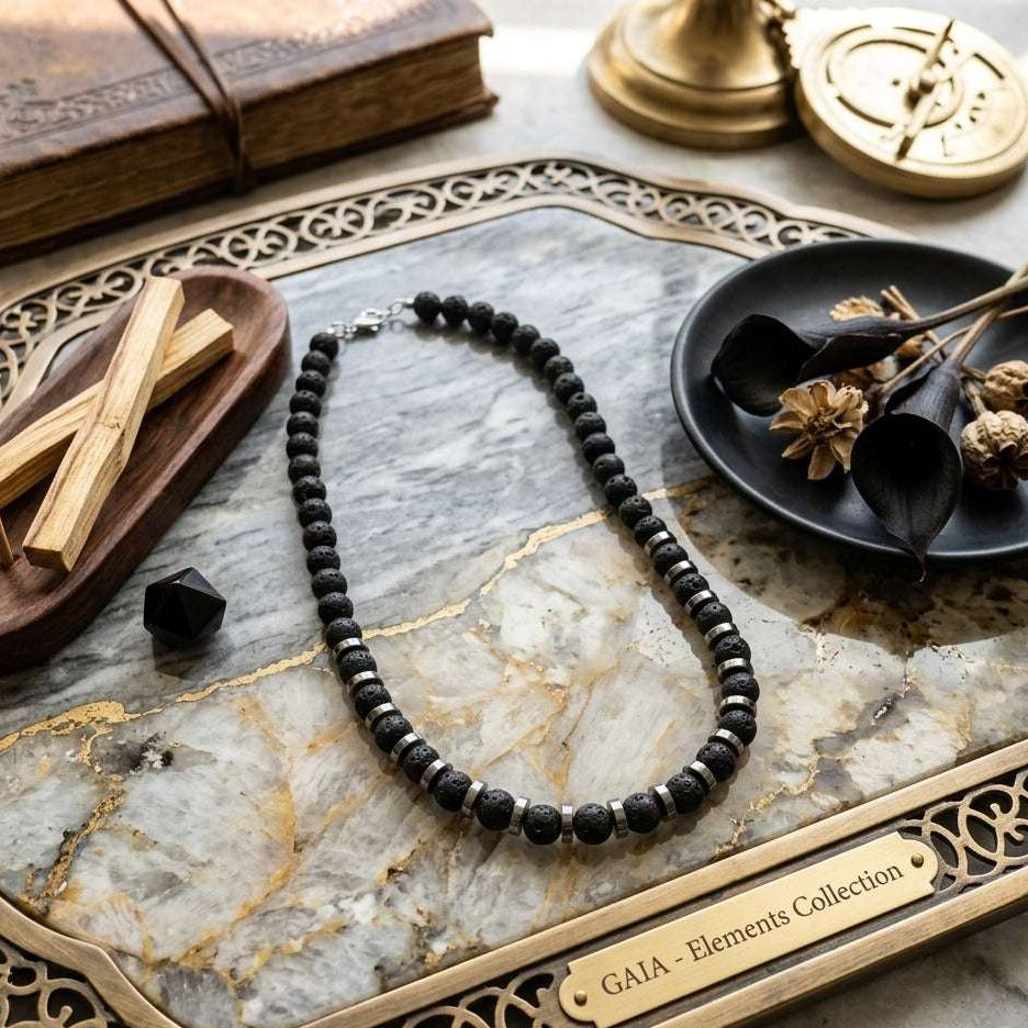 Black beaded necklace on a marble tray with decorative items
