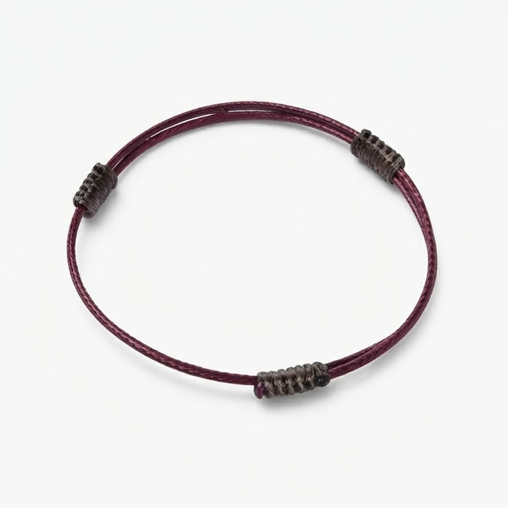 Minimal burgundy cord bracelet with dark wrapped knot details.