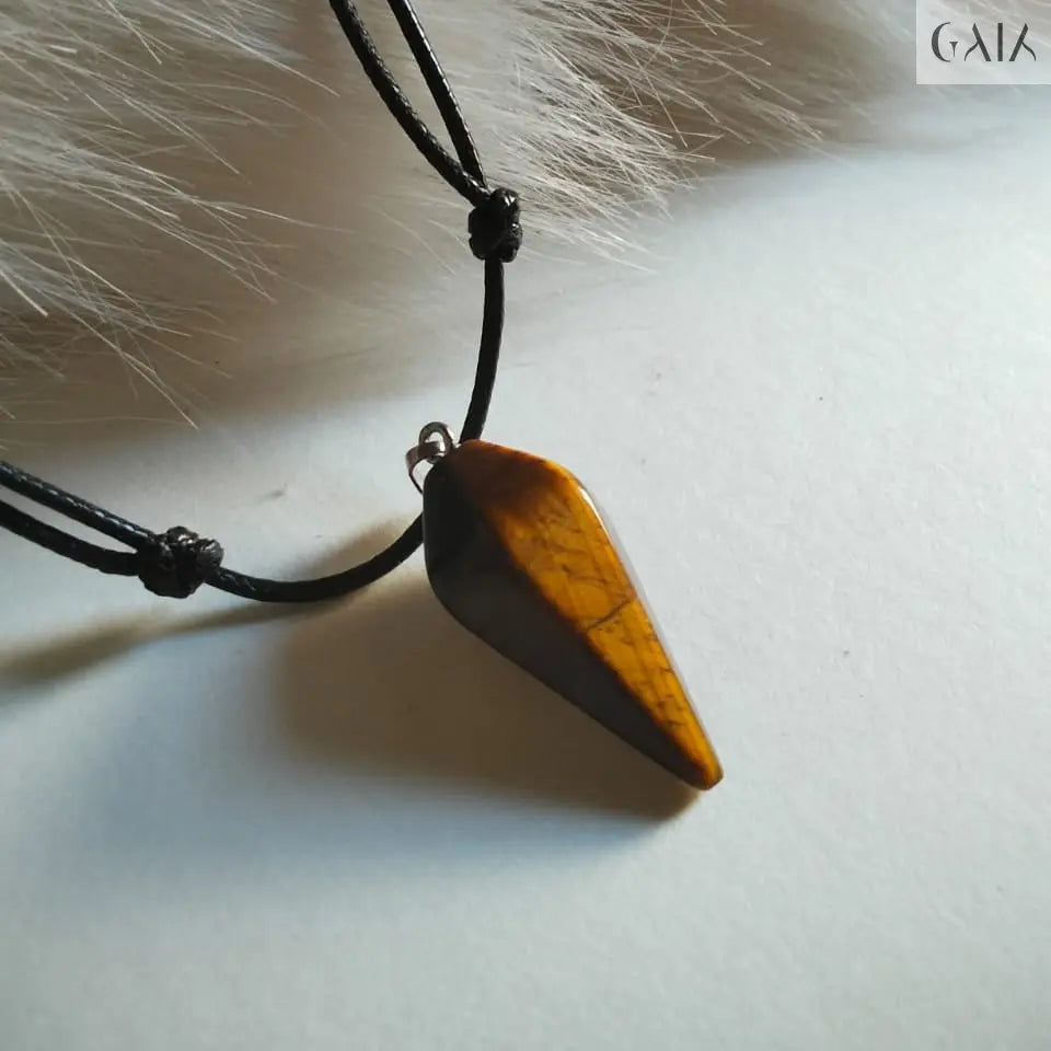 Wooden pendant on a black cord against a fur background