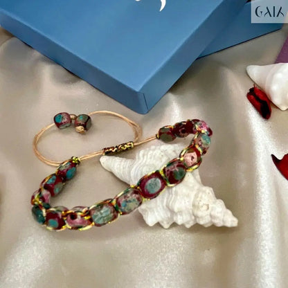 Colorful beaded bracelet on a white shell with a blue box labeled 'GAIK' in the background.