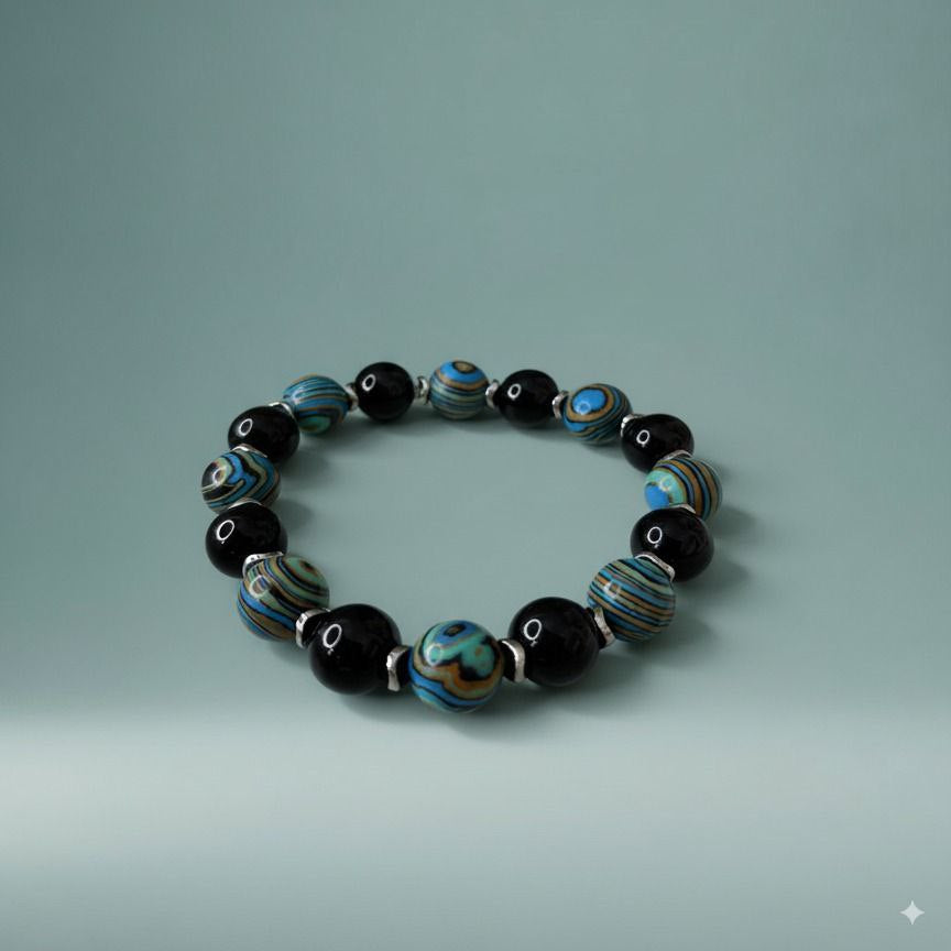 Beaded bracelet with black, blue, and silver beads on a light gray background