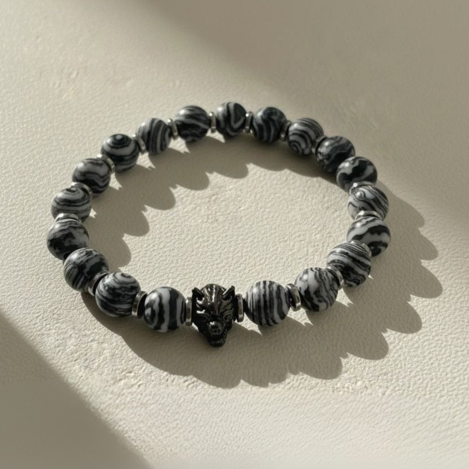 Black and white beaded bracelet on a beige background with 'GAIA' branding.