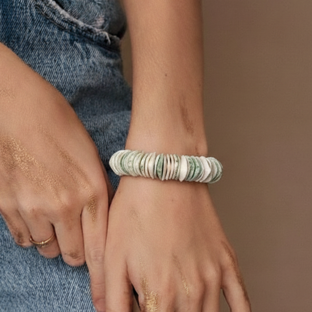 Person wearing a bracelet on a neutral background