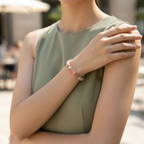 Person wearing a green sleeveless top with a blurred outdoor background