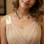 Woman wearing a necklace with a beige dress against a neutral background