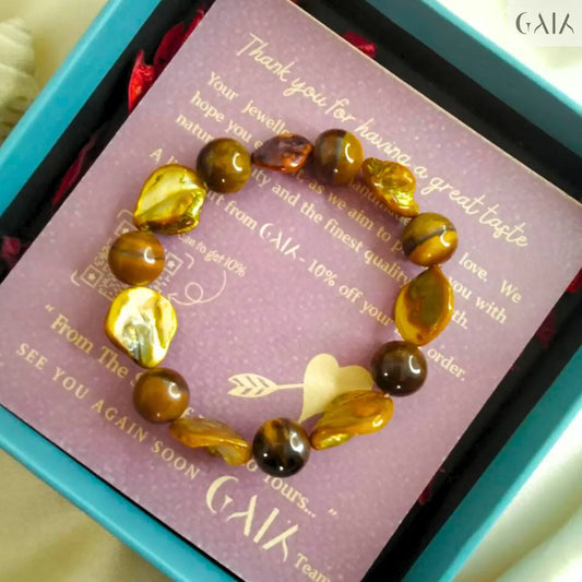 tiger eye bracelet in a box with a card from 'Cala'.