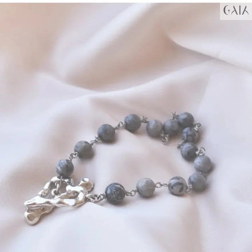 Elegant Grey Labradorite Bracelet with natural shimmering beads and unique silver charm on soft fabric background