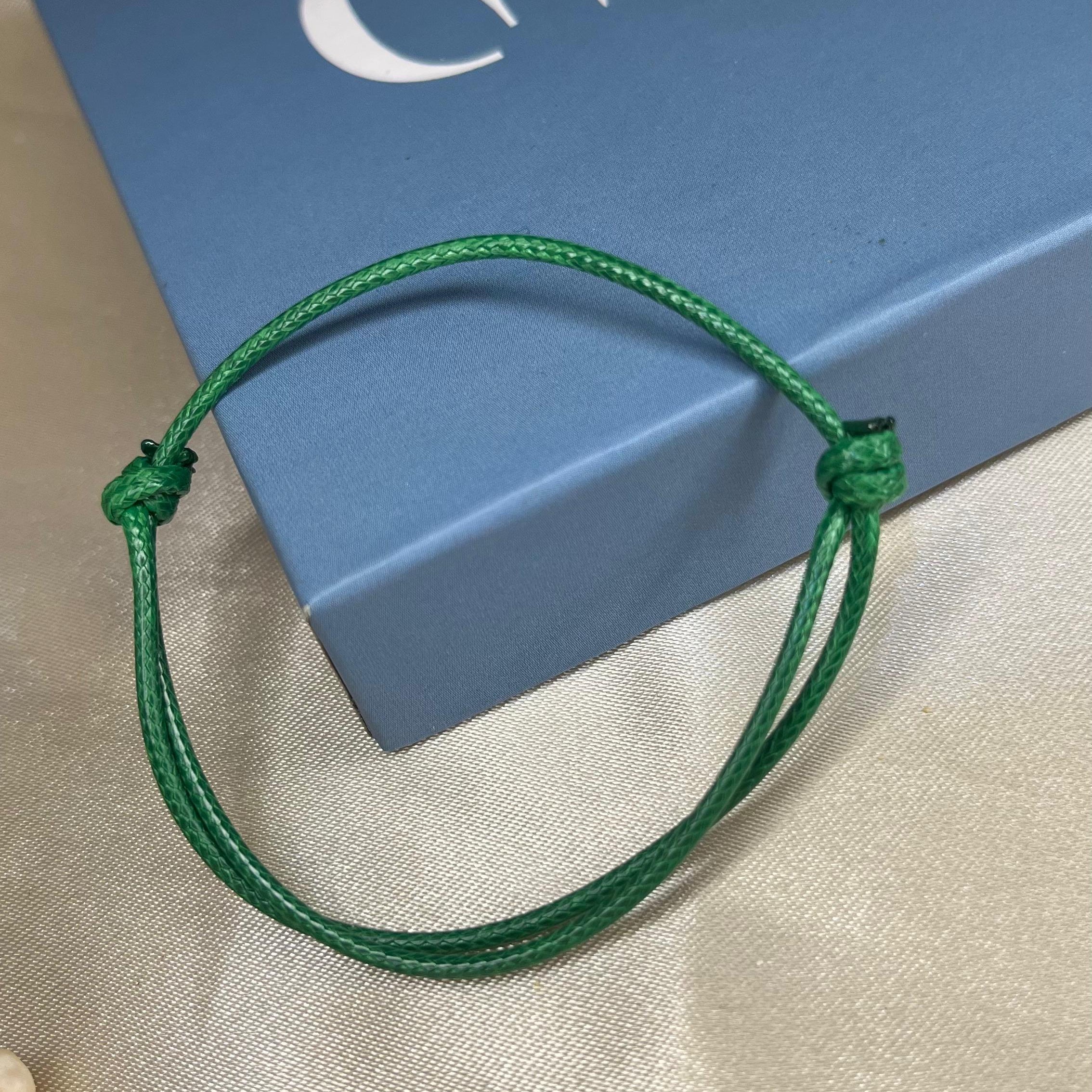 Green bracelet on a blue box with 'GAIA' branding.