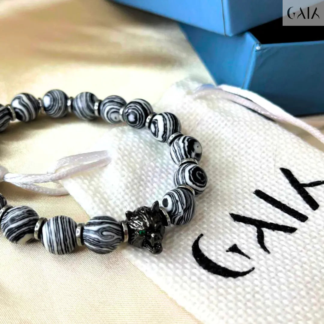 Black and white beaded bracelet on a white drawstring bag with 'Galia' branding.