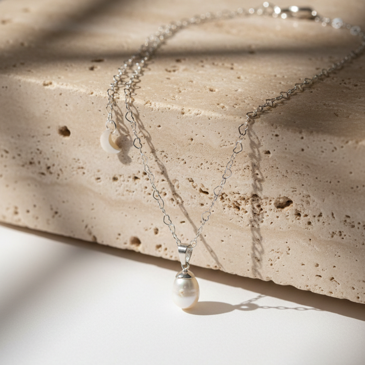 Pearl necklace on a textured stone surface