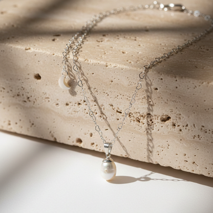 Pearl necklace on a textured stone surface