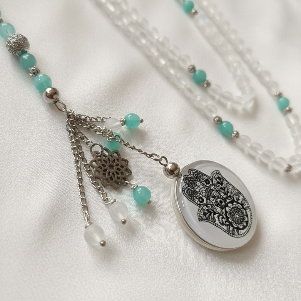 Necklace with turquoise beads and a decorative pendant on a white background
