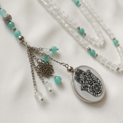 Necklace with turquoise beads and a decorative pendant on a white background