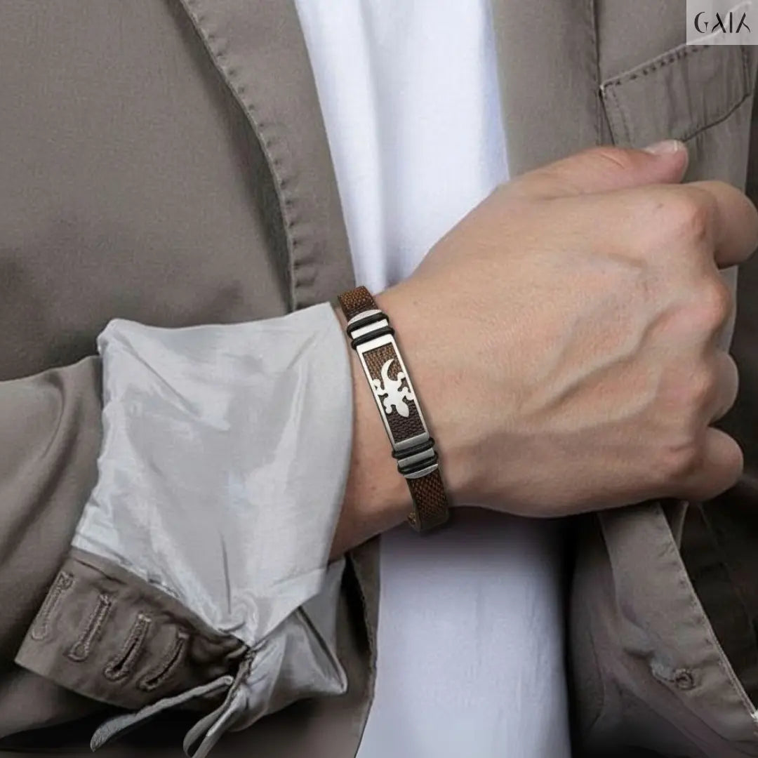 Person wearing a bracelet with a detailed design, holding a jacket sleeve.