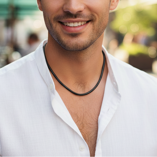 Man wearing a white shirt with a blurred outdoor background