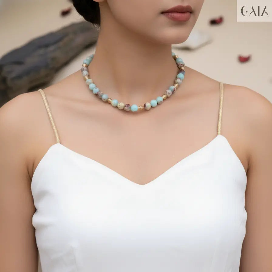 Woman wearing a beaded necklace with a blurred background