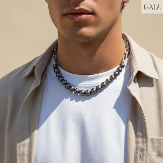 Man wearing a necklace with a neutral background