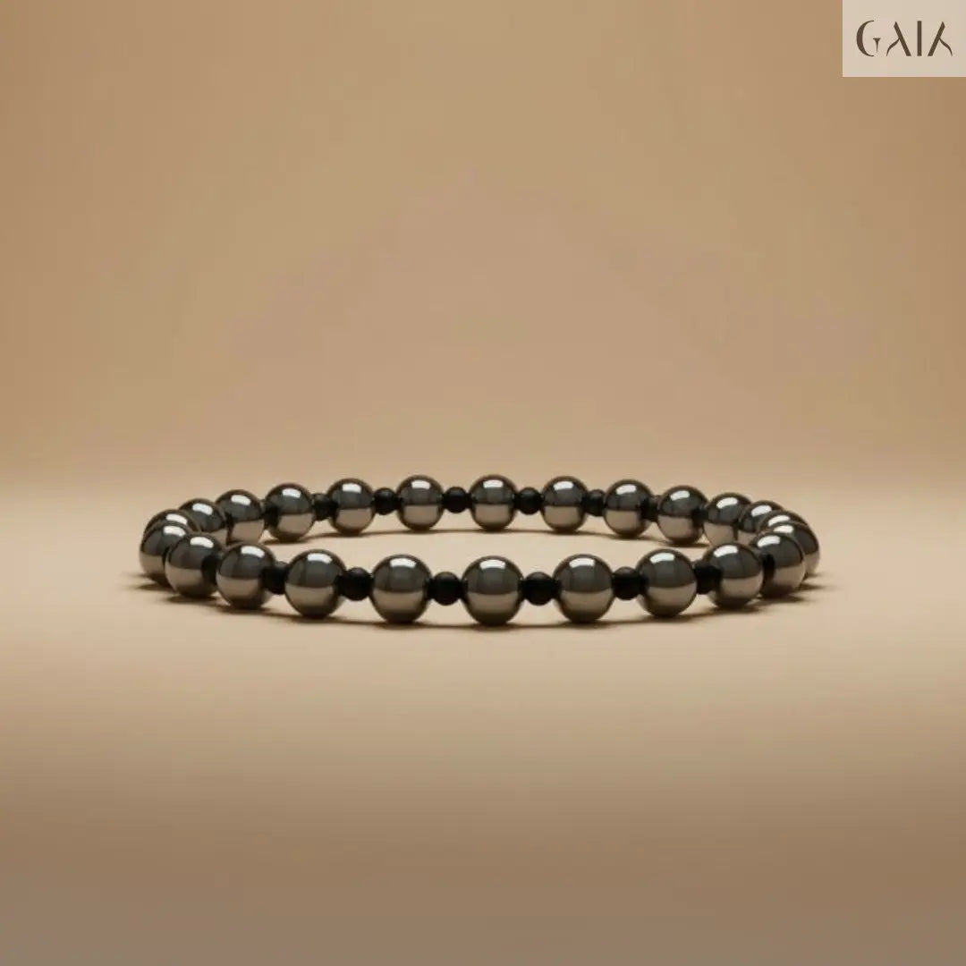 Black beaded bracelet on a beige background