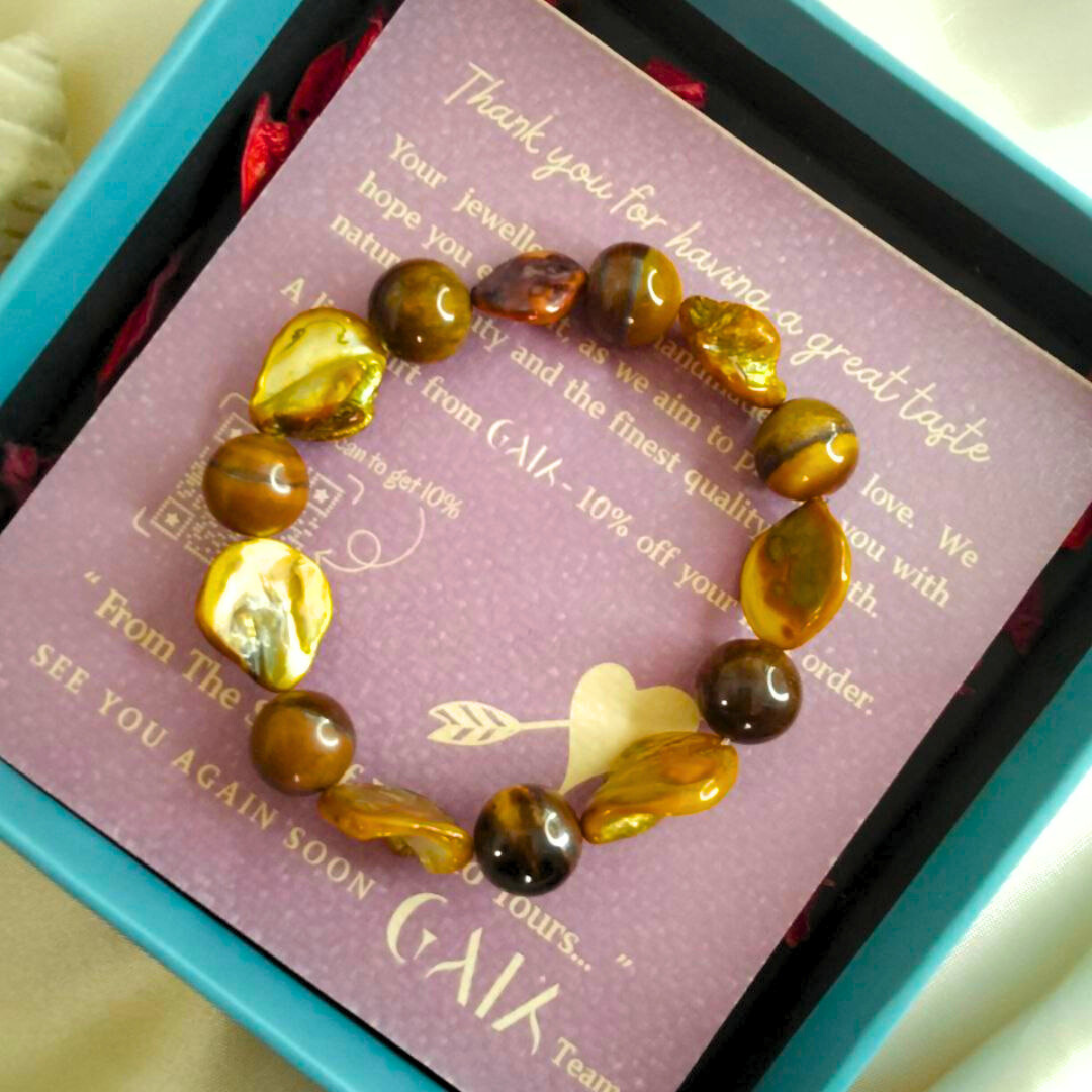 tiger eye bracelet in a box with a card from 'Cala'.